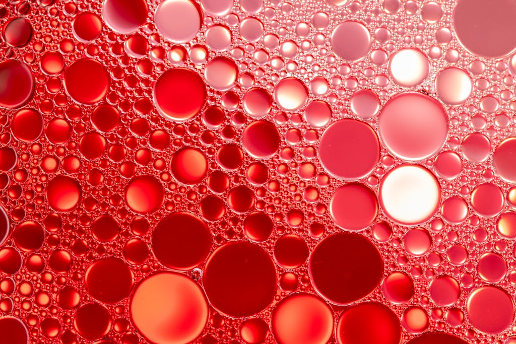 A stunning abstract composition of vibrant red oil and water bubbles creating a unique pattern.