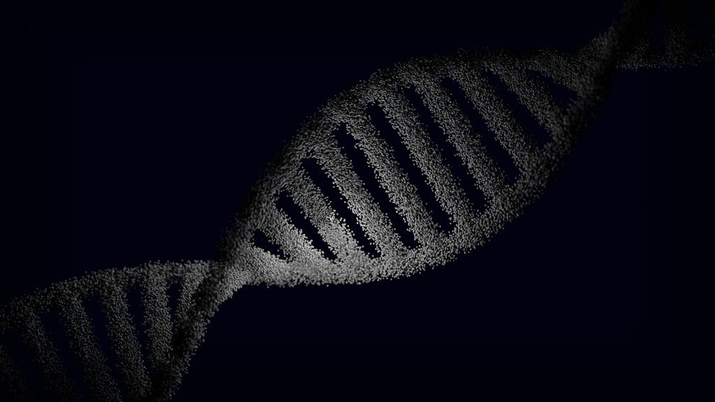 Artistic rendering of a DNA strand with particle effects against a dark background.