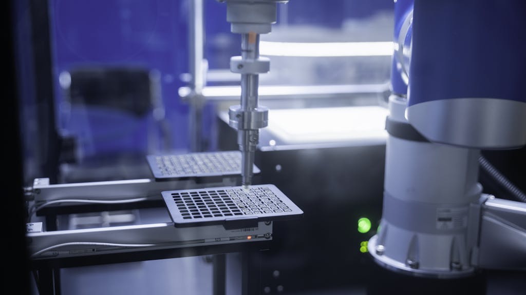 Close-up of robotic arm automating lab processes with precision.